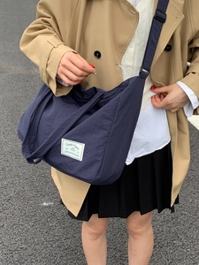 Large dark blue canvas tote bag with adjustable shoulder strap and Everyday Carry label