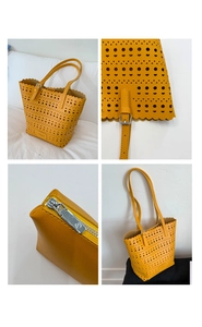Macro view of yellow laser-cut tote bag details with scalloped edges and metal hardware