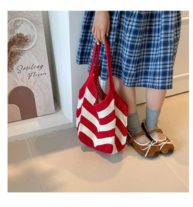 Detail of red and white diagonal striped knit tote bag with handmade texture