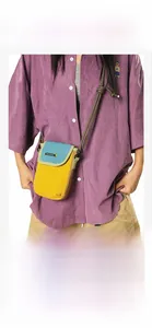 Macro detail of waterproof nylon crossbody phone bag with vibrant yellow and green contrast