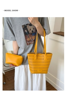 Model show of yellow laser-cut hollow tote bag and matching zipper clutch set