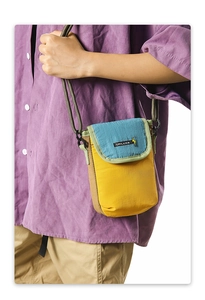 Close-up of minimalist color-block crossbody phone bag with adjustable rope strap detail