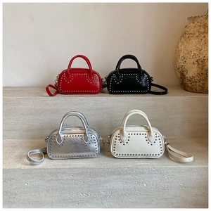 Four colors of mini boston bags with punk rivets on elegant stone steps display