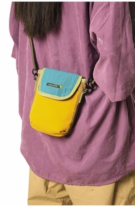 Detail of tear-resistant nylon mini crossbody bag showing stitching and metal D-ring
