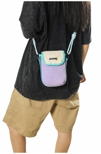 Detail of multi-color crossbody phone bag featuring violet nylon and logo lettering