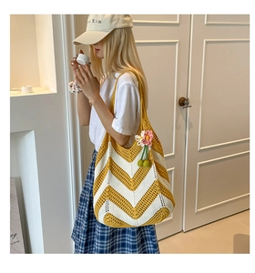 Detail of yellow and white wavy crochet shoulder bag with 3D floral pendant charm