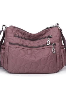 Purple nylon crossbody bag with heart quilting and multiple functional zipper pockets