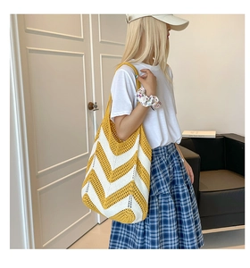 Detail of yellow and white striped crochet tote bag with woven V-pattern texture