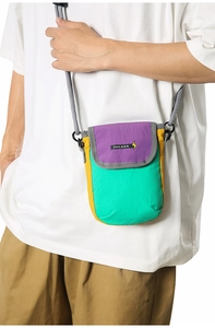 Detail of multi-color nylon crossbody phone bag with purple flap and mint green finish