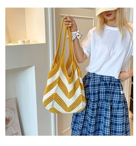 Close-up of yellow and white woven shoulder bag texture on a female model