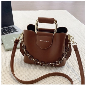 Detailed view of a brown PU leather bucket bag with metal handle and decorative chain