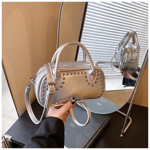 Detailed view of silver metallic crossbody bag with stylish rivet studs and top handles