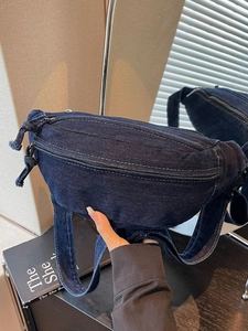 Vintage dark blue denim crescent crossbody bag with white contrast stitching and tassel