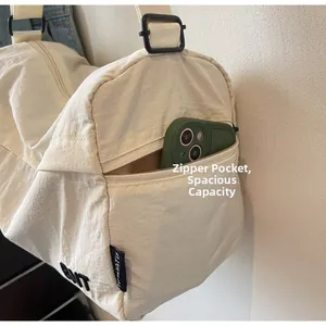 Detail of a nylon travel bag featuring a functional side zipper pocket for smartphones