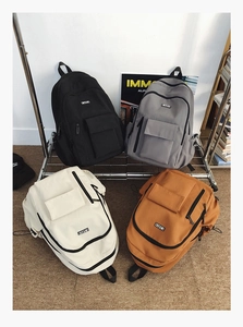Detail view of large-capacity canvas backpacks in four colors for school and travel