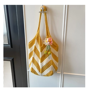 Detailed macro view of yellow and cream V-stripe knit texture with 3D flower charm