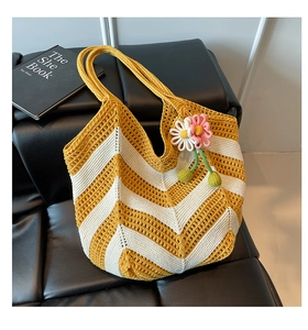 Close-up of hand-woven yellow and white crochet tote bag showing wave pattern details