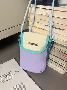 Minimalist multicolor nylon crossbody phone bag with adjustable woven strap and brand label