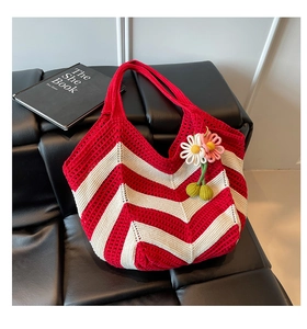 Detail of hand-woven crochet tote with red and white wave stripes and floral charms