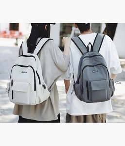 Detailed view of large capacity casual backpacks in beige and grey with MYJC logo patch
