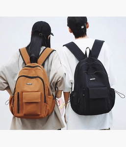 Detailed view of large-capacity nylon backpacks in brown and black with padded straps