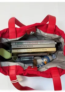 Top view of red canvas tote bag showing spacious interior with magnetic closure and items