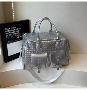 Detail showing silver woven texture travel bag with dual pockets and removable strap
