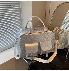 Detailed close-up of silver woven texture PU leather travel bag with dual front flap pockets