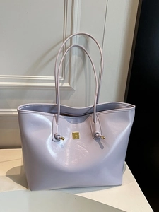 Large purple glossy leather tote bag with gold logo hardware and knotted shoulder strap