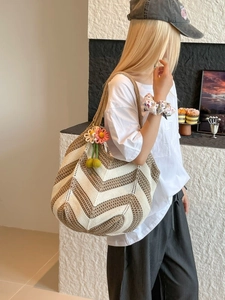 Minimalist hand-woven crochet tote bag with V-shaped stripes and floral cherry pendant