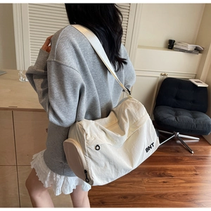 Off-white nylon sports travel bag with BNT print and adjustable wide shoulder strap