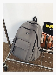 Detailed side view of dark grey waterproof backpack featuring side buckle and bottle pocket