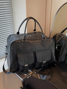 Large black woven leather travel bag with multi-pockets and adjustable shoulder strap