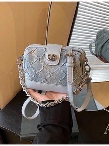 Light blue denim handbag with quilted texture, silver chain, and crossbody strap