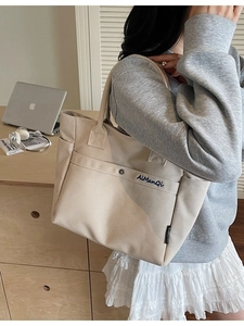Large beige canvas tote bag with AlManQi embroidery and front snap pocket for daily commute
