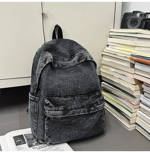 Detailed view of large acid-wash denim backpack with multi-pocket design for travel