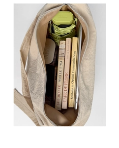 Top view of spacious interior of canvas crossbody bag showing ample storage space