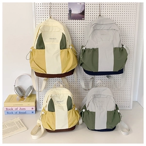 Detail view of water-resistant nylon backpacks in yellow and gray two-tone combinations