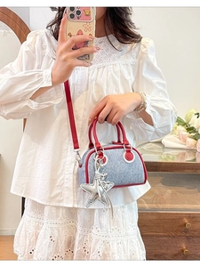 Mini borsa Boston in denim blu con manici in pelle rossa e ciondolo a stella argento