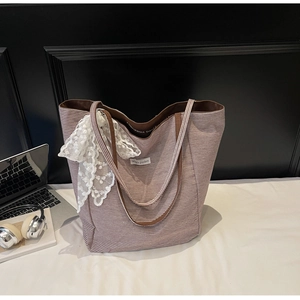 Detailed shot of large striped canvas tote with lace bow and Magic Pocket label