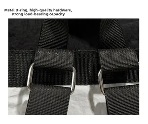Close-up of durable silver metal square rings and heavy-duty nylon straps on a black backpack