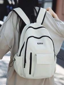 Minimalist white nylon backpack with black contrast details and multi-pocket design
