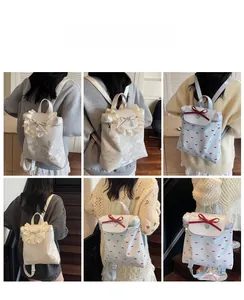 Detailed views of bow-knot backpacks in creamy white and light blue for student style