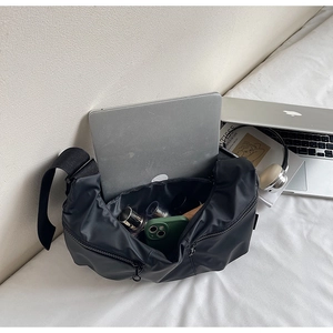 Top view of large black nylon crossbody bag showing spacious interior and daily essentials