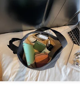 Interior view of black tote bag showing large capacity for tablet and daily items