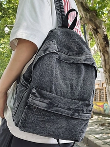 Outdoor shot of a vintage washed denim backpack in dark grey with spacious compartments