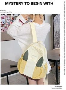 Detail of color-block nylon backpack featuring drawstring side pocket and ROYBAO logo