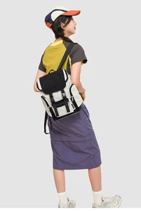 Outdoor leisure backpack in cream and black featuring functional buckles and side pockets