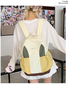Detail of color-block backpack side pocket with drawstring and buckle for outdoor travel