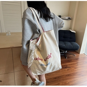 Off-white canvas tote bag with Crème Glacée print and delicate lace ribbon detail